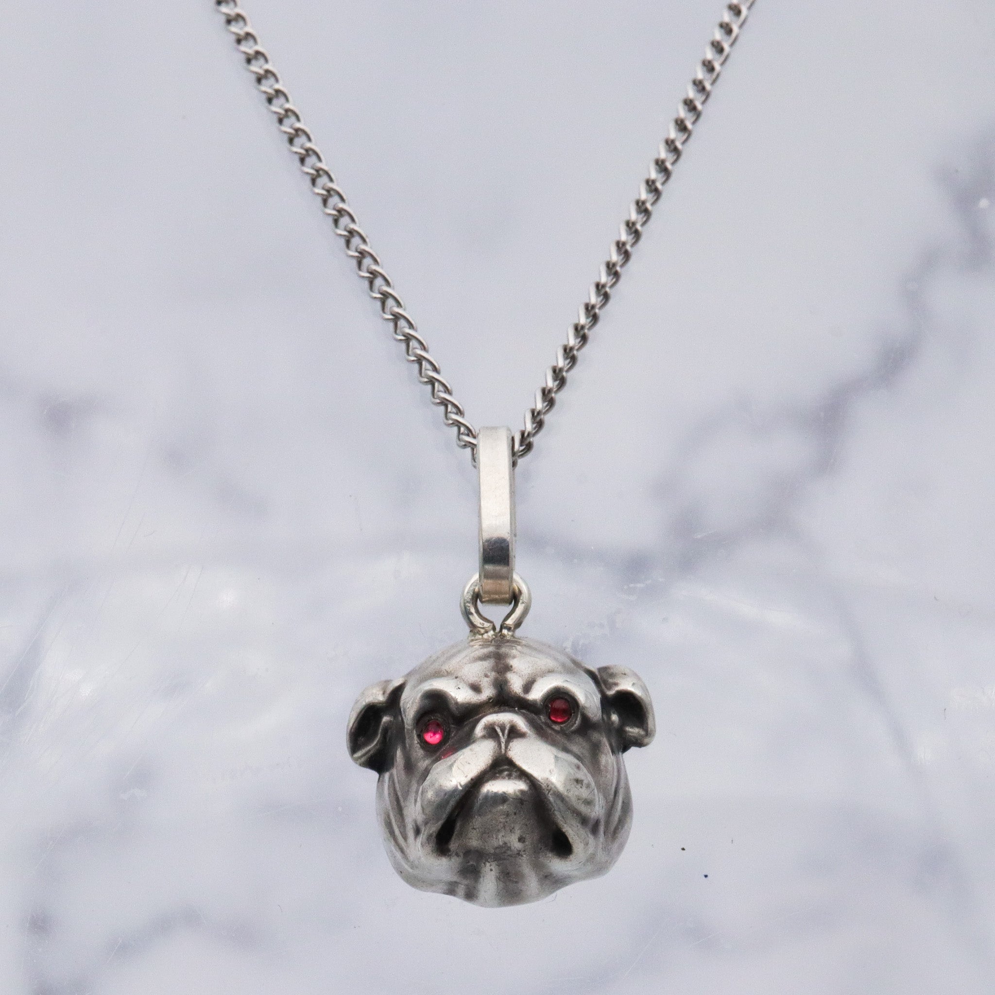 Antique Unger Brothers sterling silver bulldog with ruby glass eyes pendant